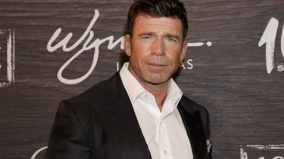 Taylor Sheridan standing at the world premiere reception of 1883.