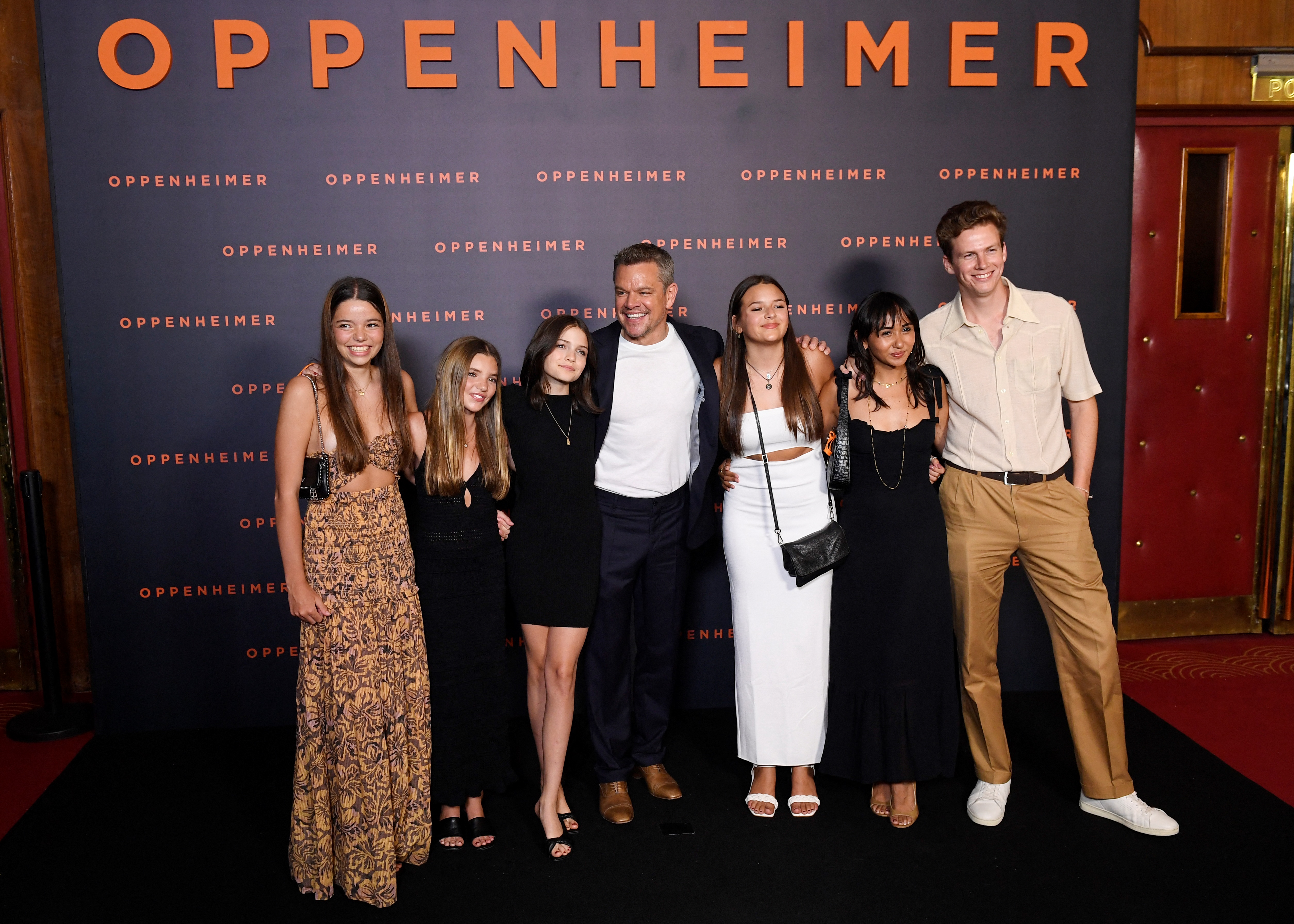 Matt Damon (C) poses with his daughters Stella Damon, Gia Damon and Alexia Barroso upon their arrival for the "Premiere" of the movie "Oppenheimer" at the Grand Rex cinema in Paris on July 11, 2023.