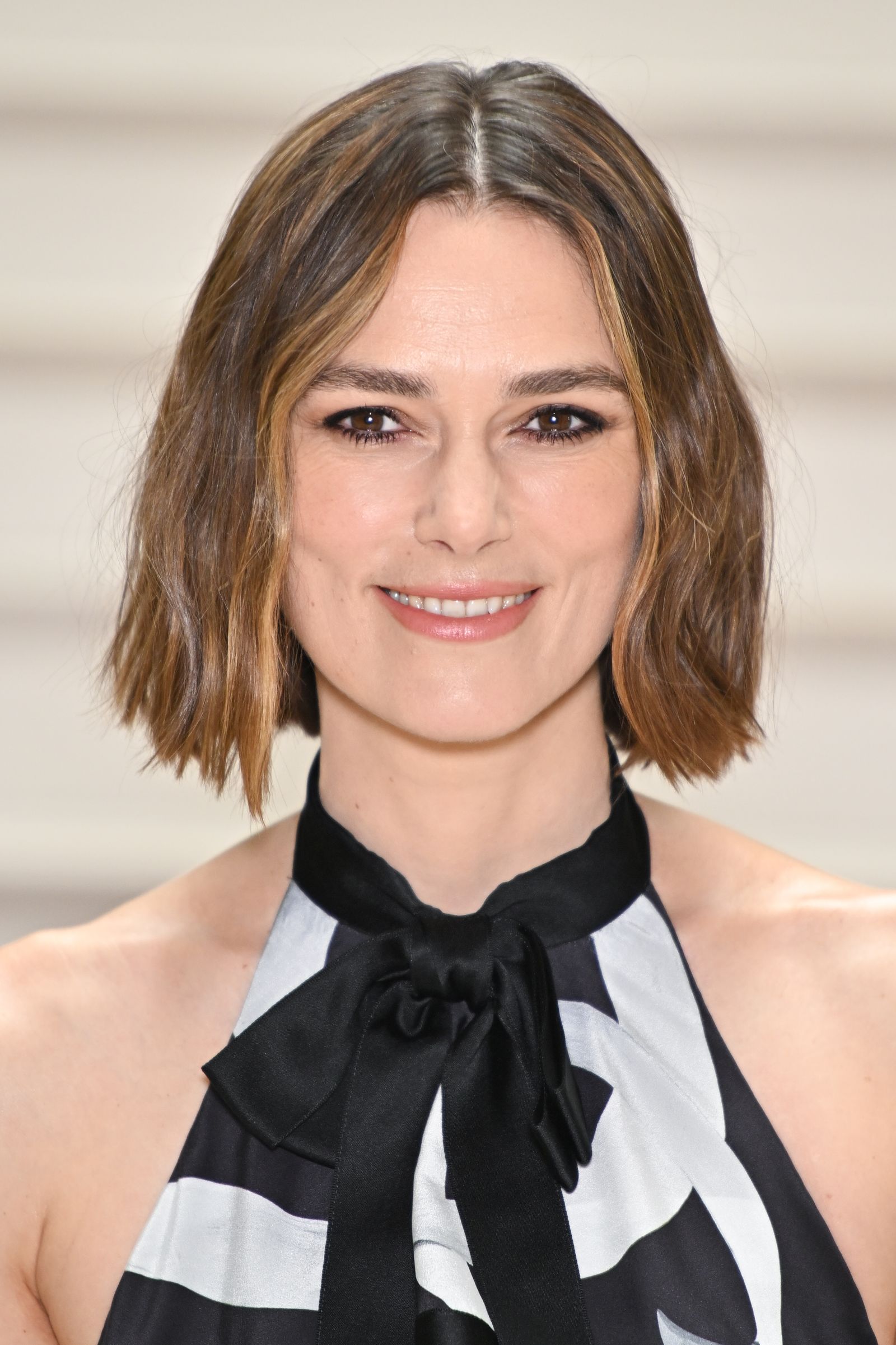 Image may contain Keira Knightley Head Person Face Photography Portrait Adult Body Part Neck Happy and Smile