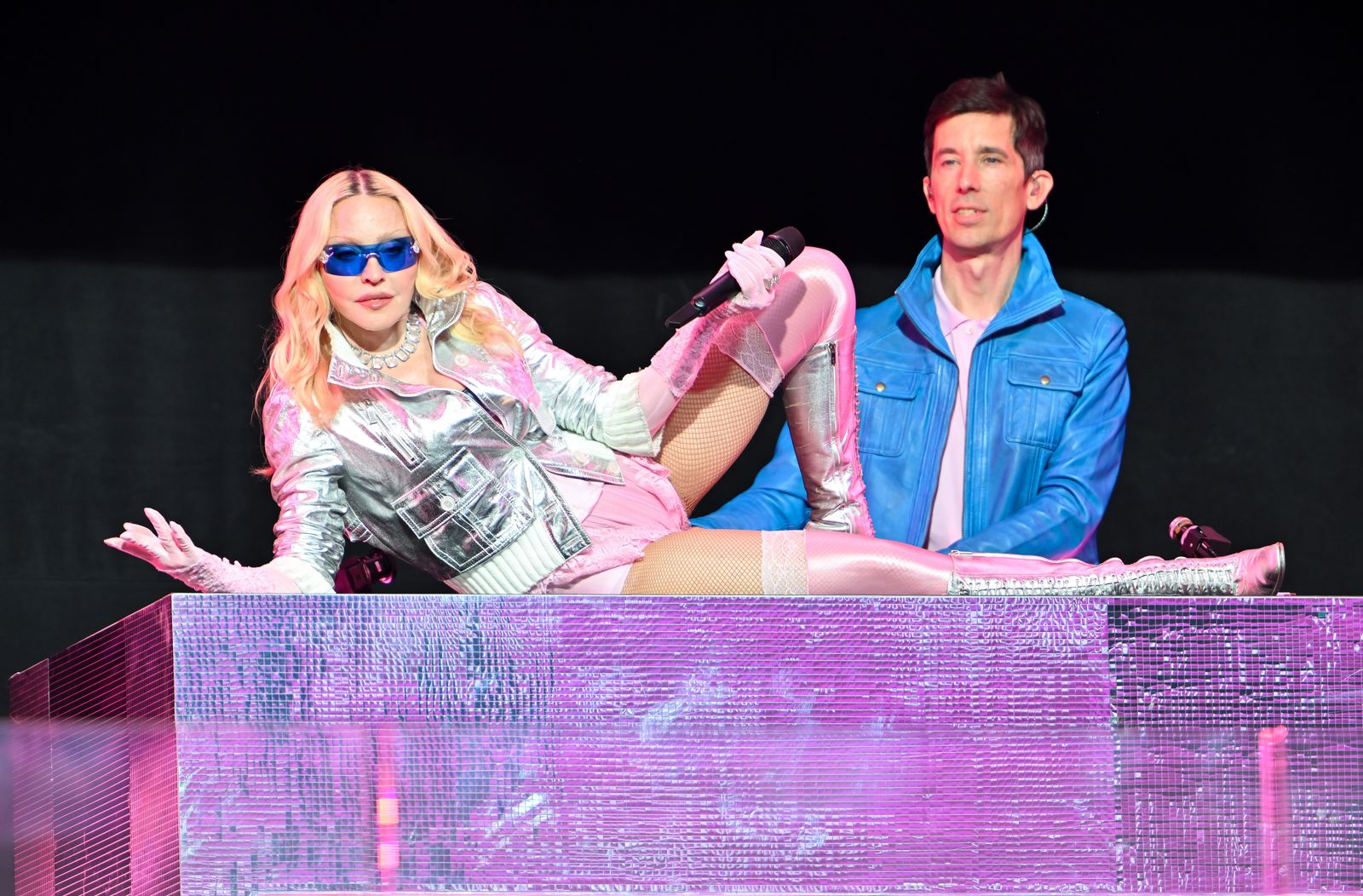 Image may contain Stuart Price Madonna Clothing Footwear Shoe Purple Adult Person Electrical Device and Microphone