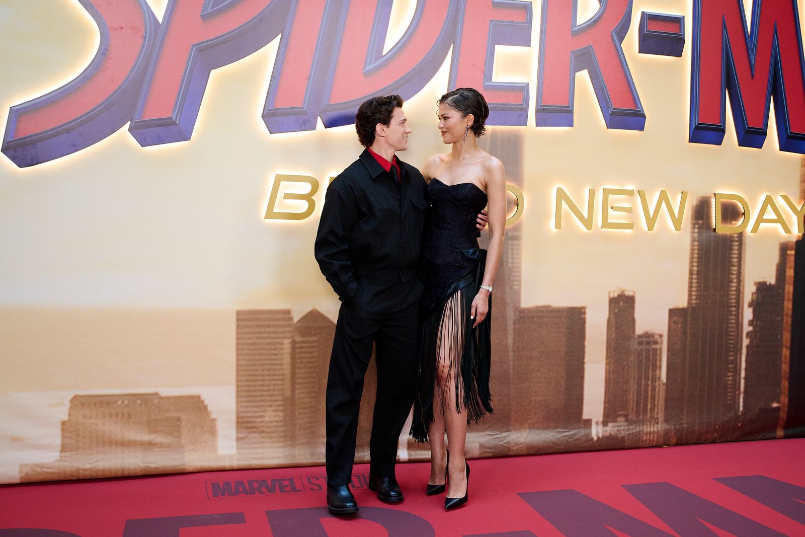 Image may contain Tom Holland Zendaya Fashion Adult Person Clothing and Coat