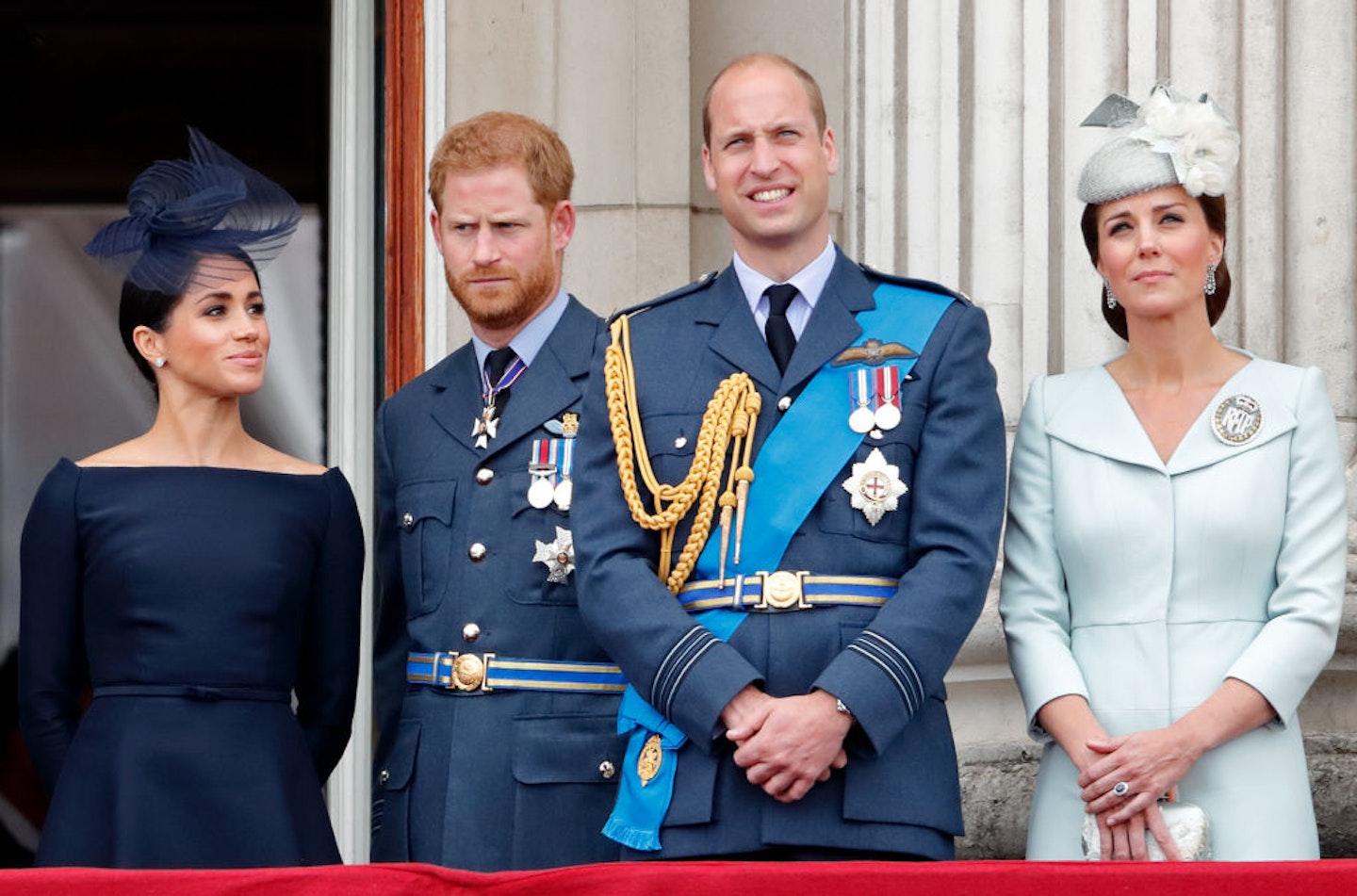 Meghan, Duchess of Sussex, Prince Harry, Duke of Sussex, Prince William, Duke of Cambridge and Catherine, Duchess of Cambridge watch a flypast to mark the centenary of the Royal Air Force from the balcony of Buckingham Palace