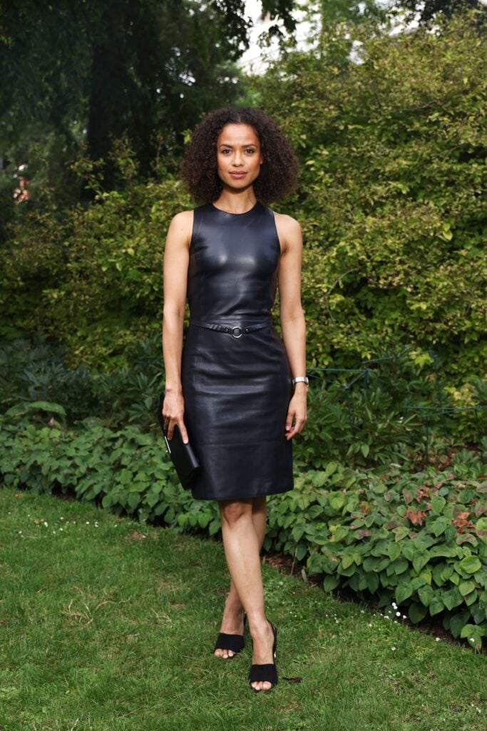 Gugu Mbatha-Raw wearing a sleeveless black Hermès leather dress at the Hermès Maison Bond Street opening in London