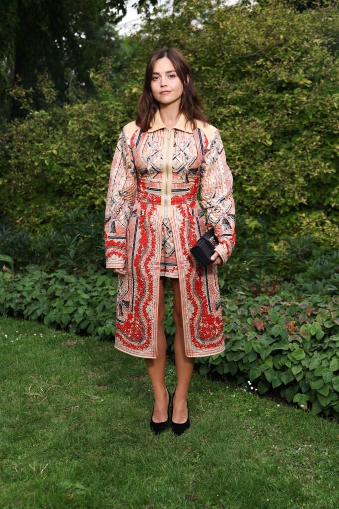 Jenna Coleman wearing a patterned Hermès coat and mini dress at the Hermès Maison Bond Street opening in London