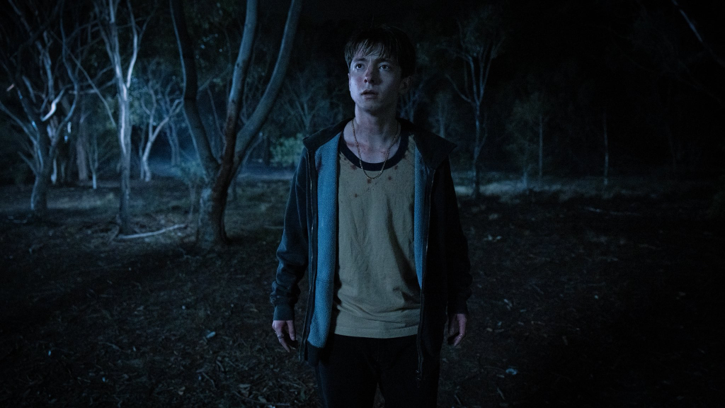 Leviticus still: nighttime, a boy in the dark looking scared