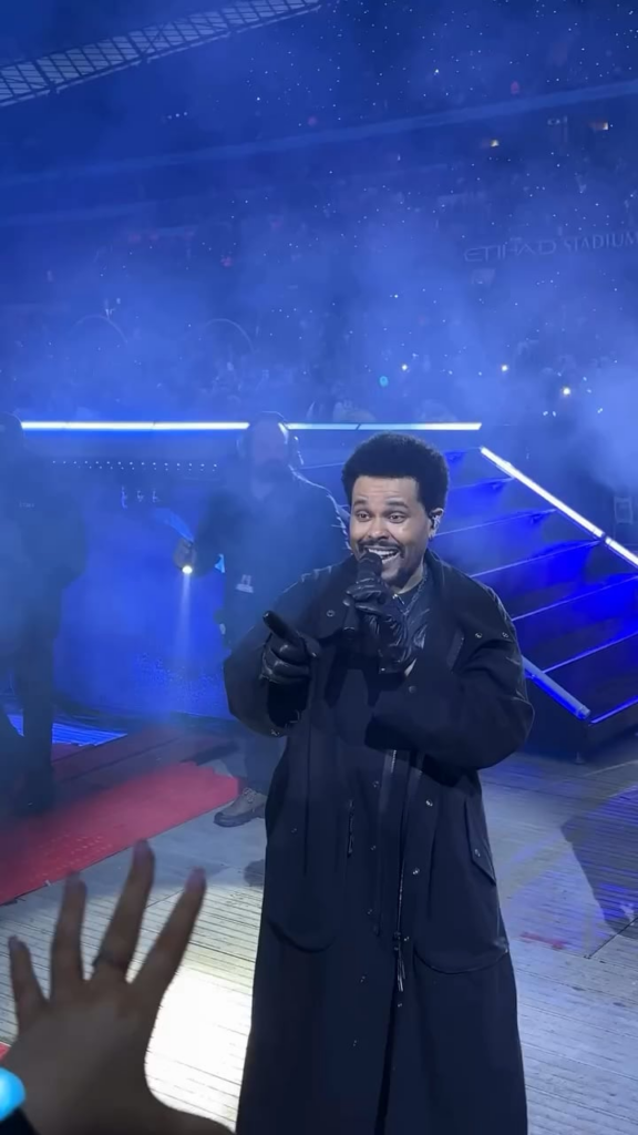 The Weeknd singing “Out Of Time” with a fan during the opening night of the European leg of his tour, in Manchester