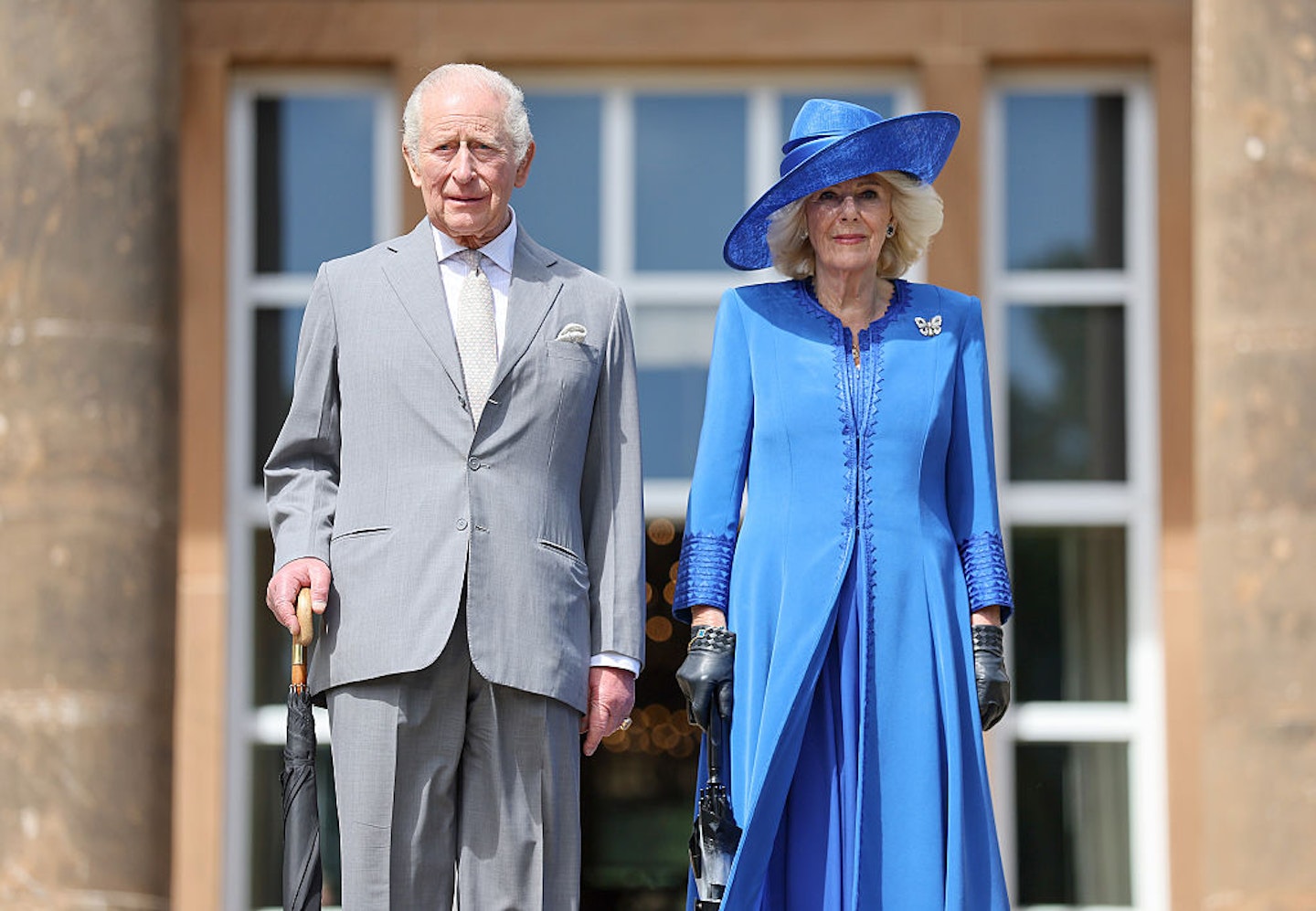 King Charles III and Queen Camilla pose on the steps as they arrive at a Garden Party at Hillsborough Castle