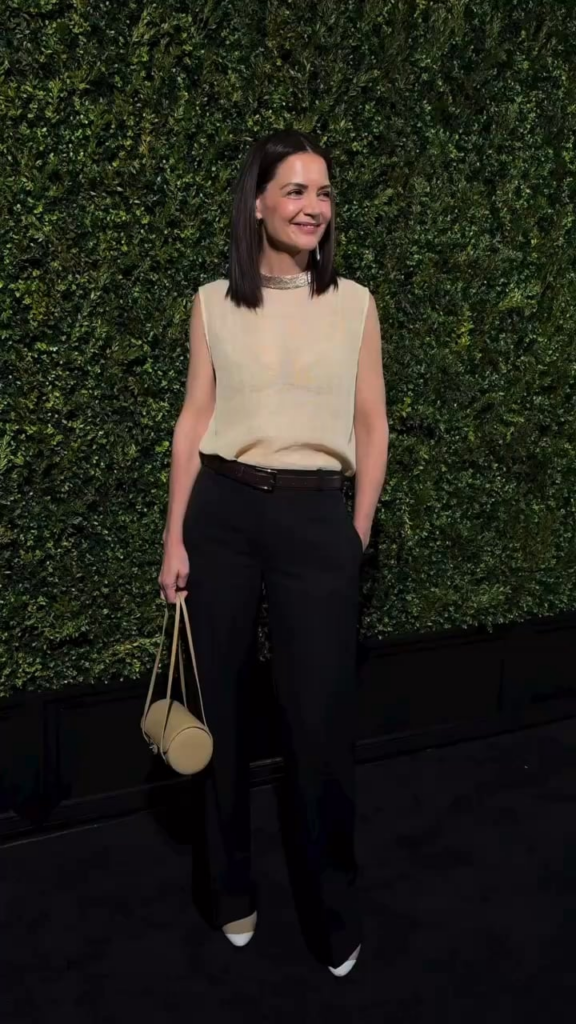 Katie Holmes wearing Chanel asking the photographers if her top was too see-through on the carpet at the Tribeca Festival Artists Dinner (June 8, 2026)