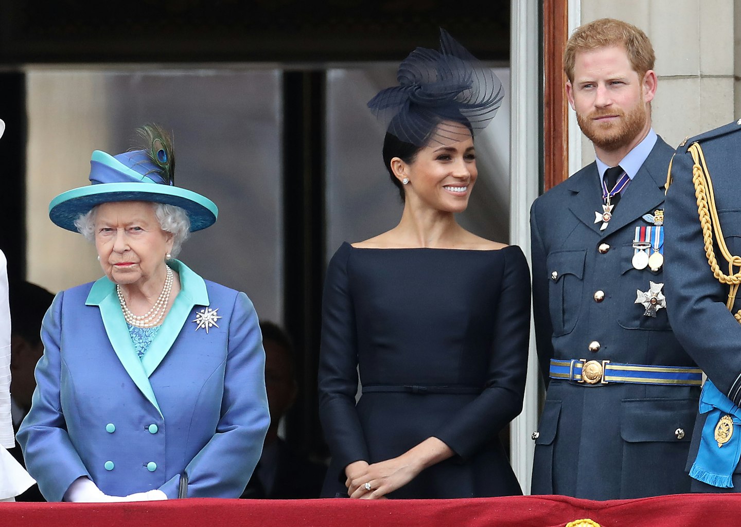 Queen Elizabeth II, Prince Harry, Duke of Sussex and Meghan, Duchess of Sussex on the balcony of Buckingham Palace as the Royal family attend events to mark the Centenary of the RAF on July 10, 2018