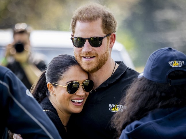 (FILES) Duke and Duchess of Sussex, Prince Harry (R) and his wife, Meghan Markle embrace at The Invictus Games in The Hague on April 16, 2022. Prince Harry, Duke of Sussex, Meghan, Duchess of Sussex and their children are to make their first family visit to Britian in four years, it was reported on June 17, 2026. (Photo by Remko de Waal / ANP / AFP via Getty Images) / Netherlands OUT