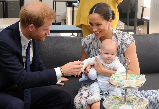(FILES) Britain's Duke and Duchess of Sussex, Prince Harry and his wife Meghan hold their baby son Archie as they meet with Archbishop Desmond Tutu (unseen) at the Tutu Legacy Foundation in Cape Town on September 25, 2019. Prince Harry, Duke of Sussex, Meghan, Duchess of Sussex and their children are to make their first family visit to Britain in four years, it was reported on June 17, 2026. (Photo by HENK KRUGER / POOL / AFP via Getty Images)