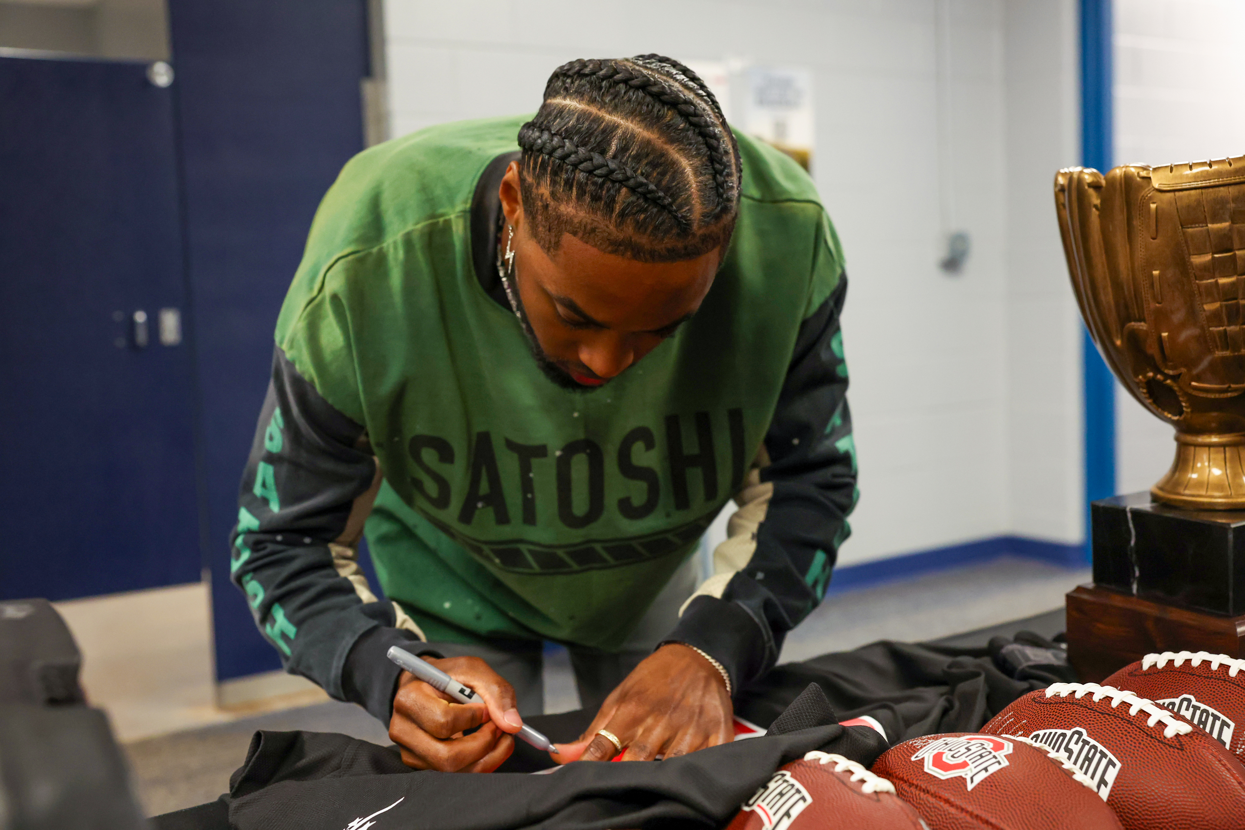Photos from the Denzel Ward celebrity softball game, June 6,...