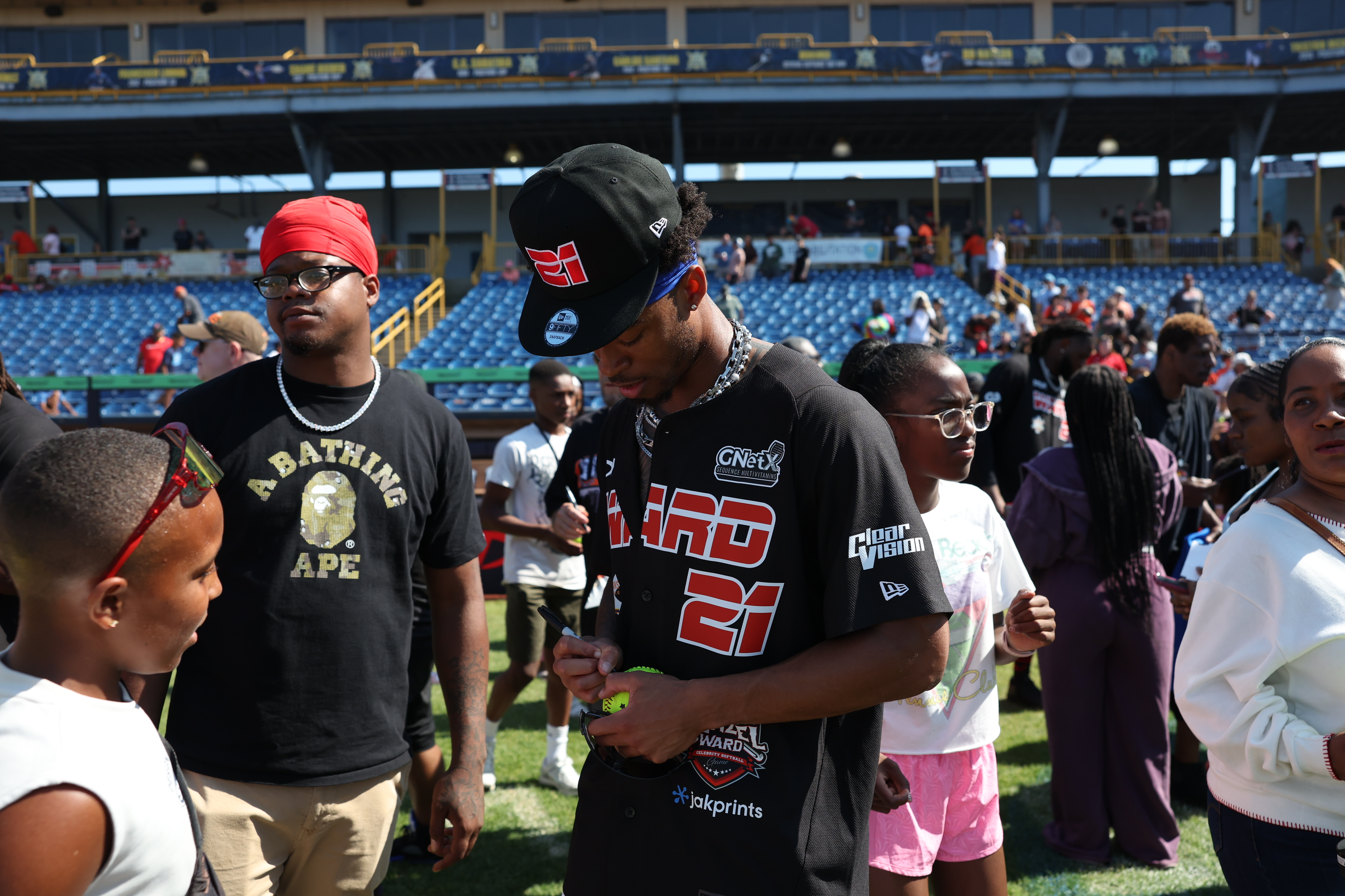 Photos from the Denzel Ward celebrity softball game, June 6,...