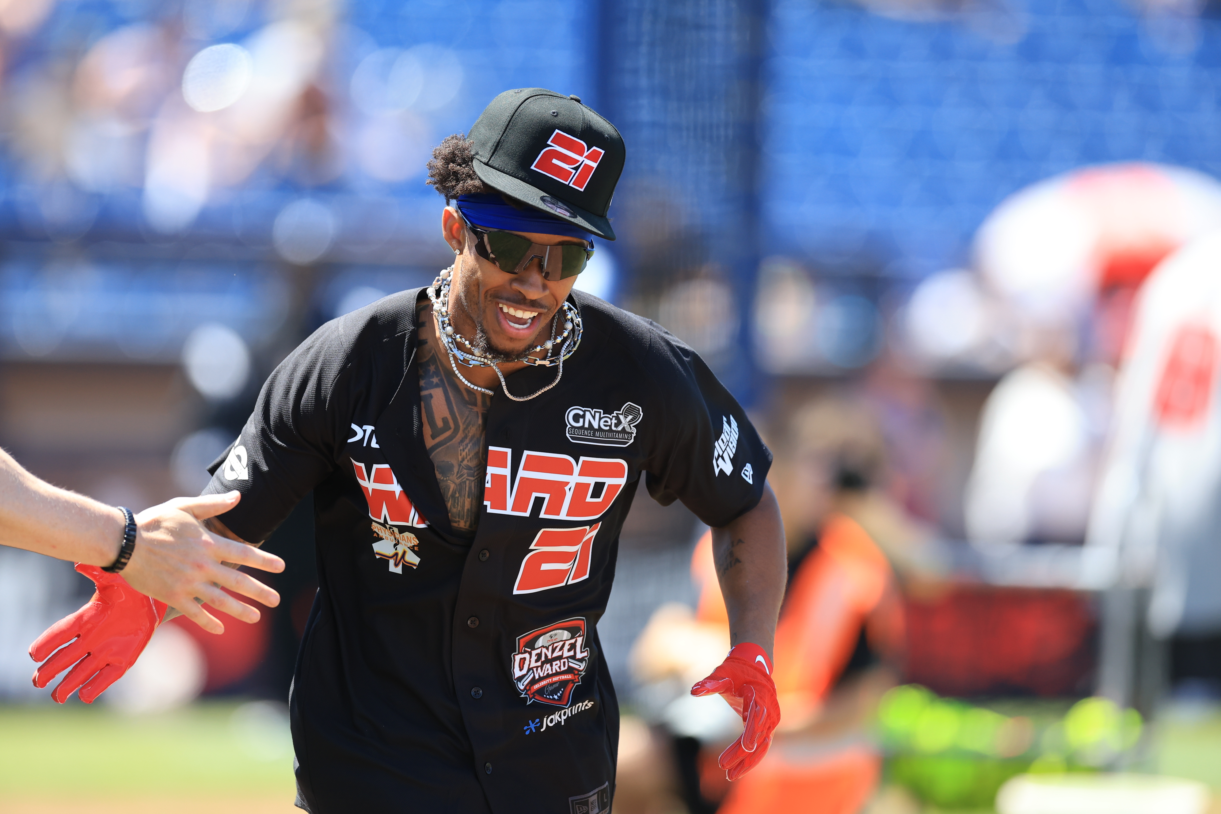 Photos from the Denzel Ward celebrity softball game, June 6,...