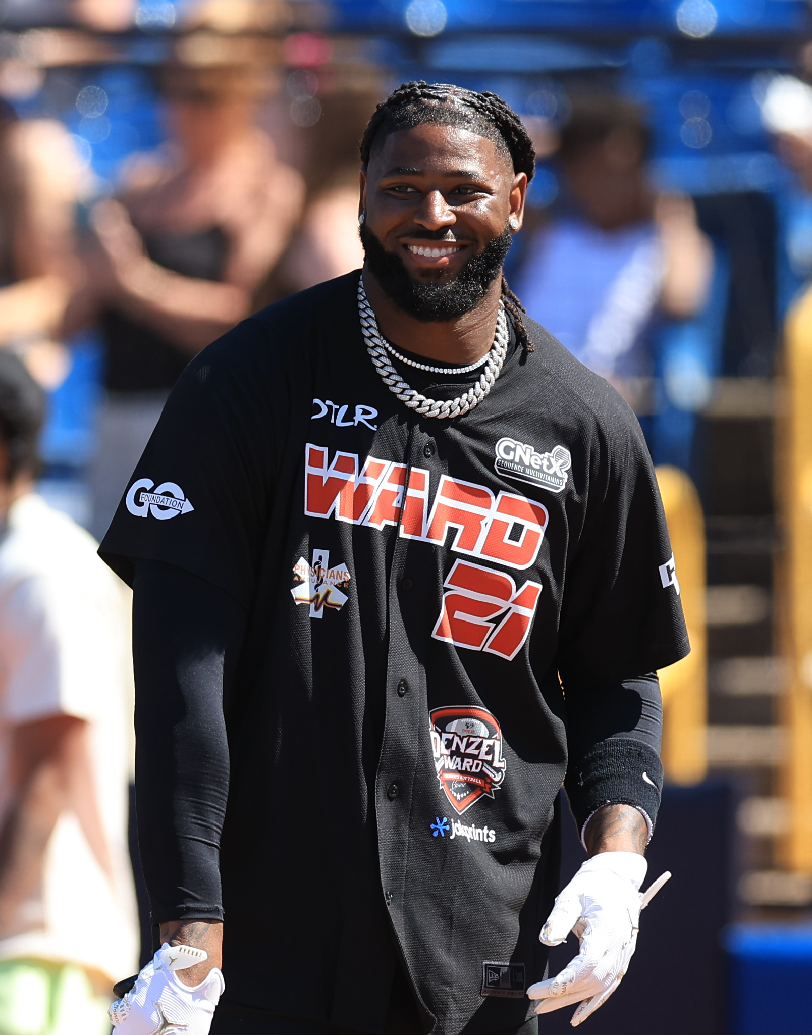 Photos from the Denzel Ward celebrity softball game, June 6,...