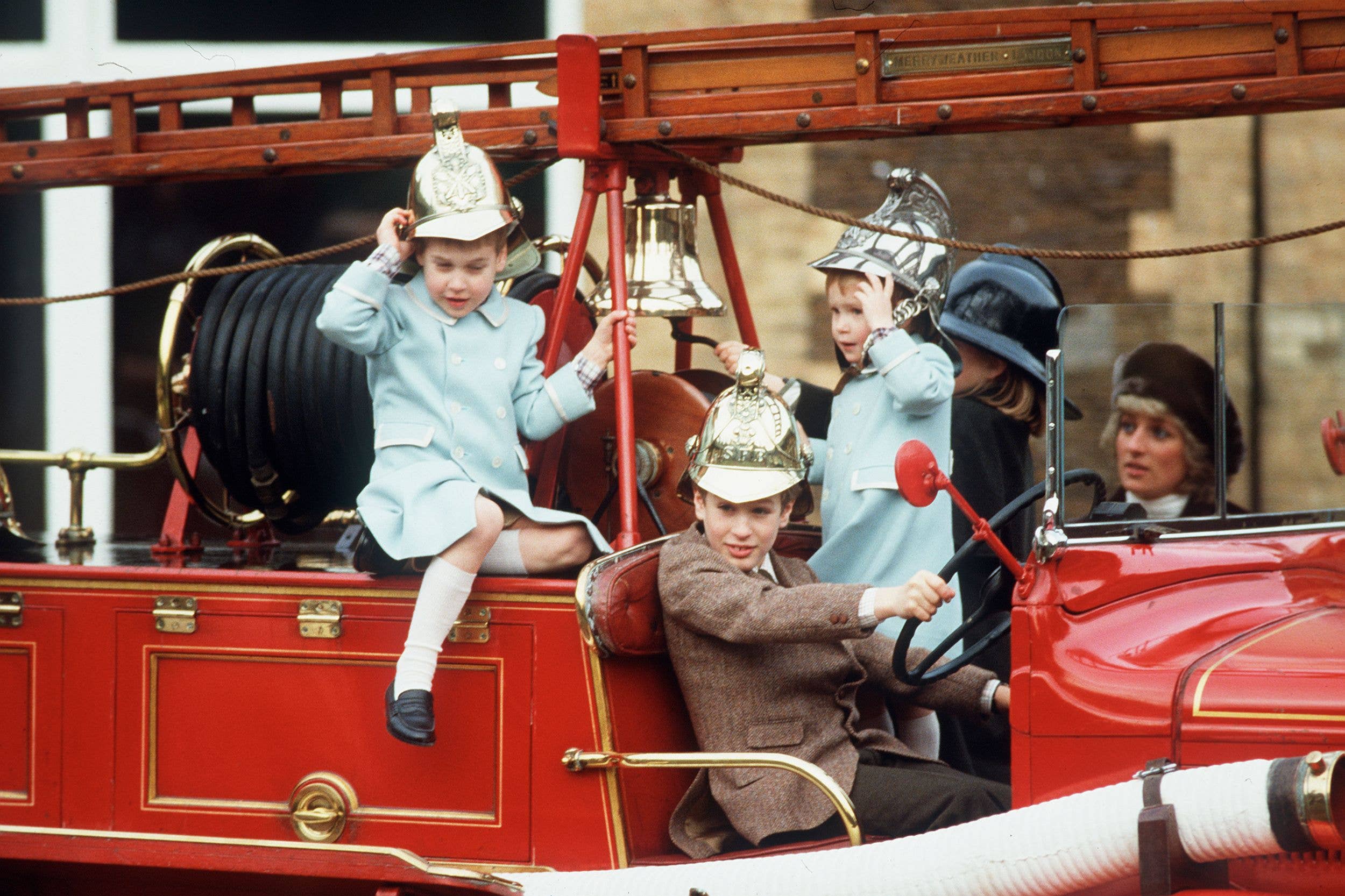Prince William, Prince Harry and Peter Phillips play on a fire engine at Sandringham on January 3, 1988