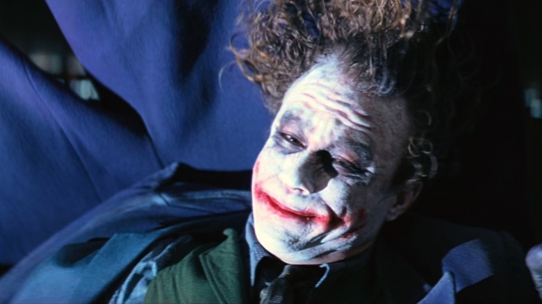 Joker hanging upside down from a rope in The Dark Knight