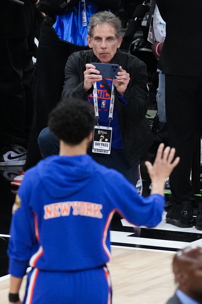 Ben Stiller taking a photo on his phone during Game 2 of the NBA Finals.