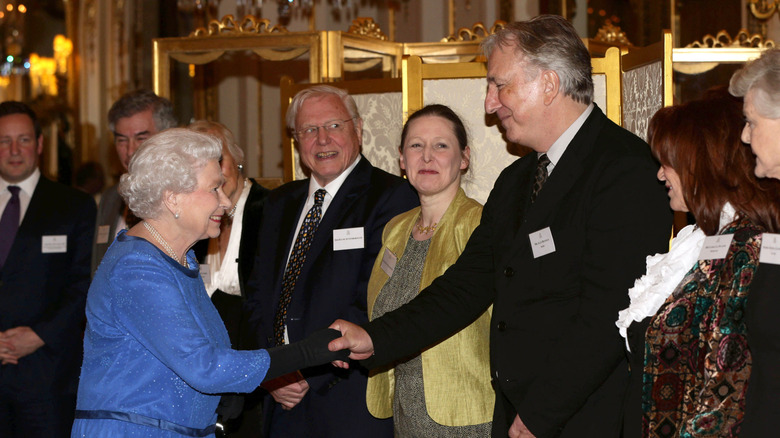 Queen Elizabeth II meets guests, including Alan Rickman, during the Dramatic Arts reception at Buckingham Palace on February 17, 2014 in London, England
