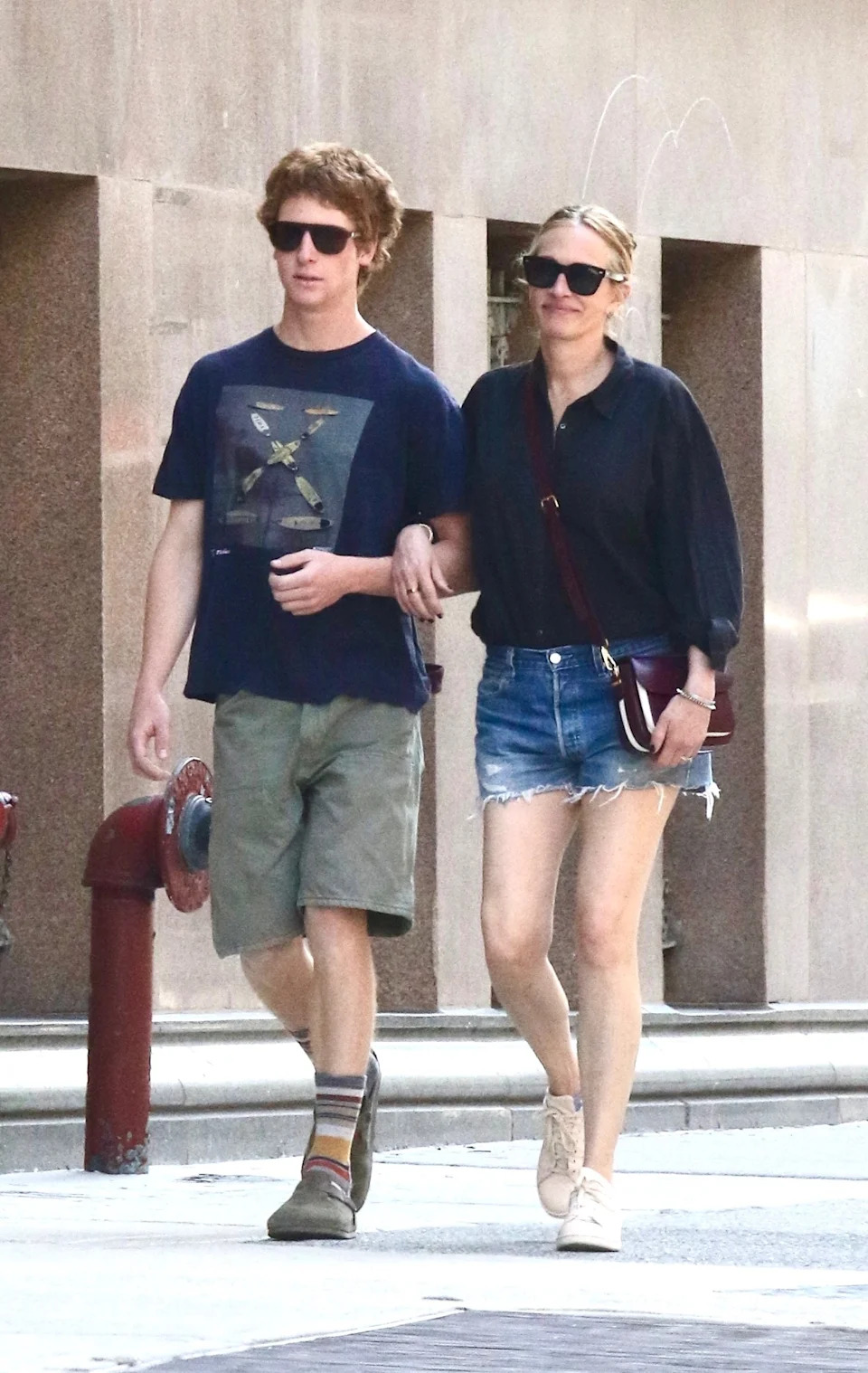 The Oscar winner wore a blue blouse tucked into jean shorts, white sneakers, a crossbody purse and black sunglasses. BrosNYC / BACKGRID