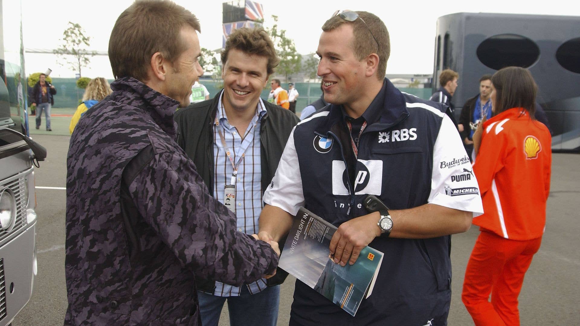 Peter Phillips shaking hands with a man at an F1 event