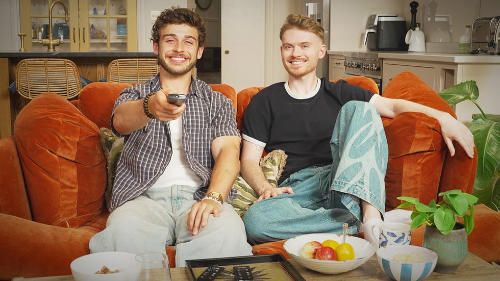 Celebrity Gogglebox 2026 cast: Full line-up of famous TV critics and where you recognise them from two individuals sitting on an orange couch with snacks and a remote control
