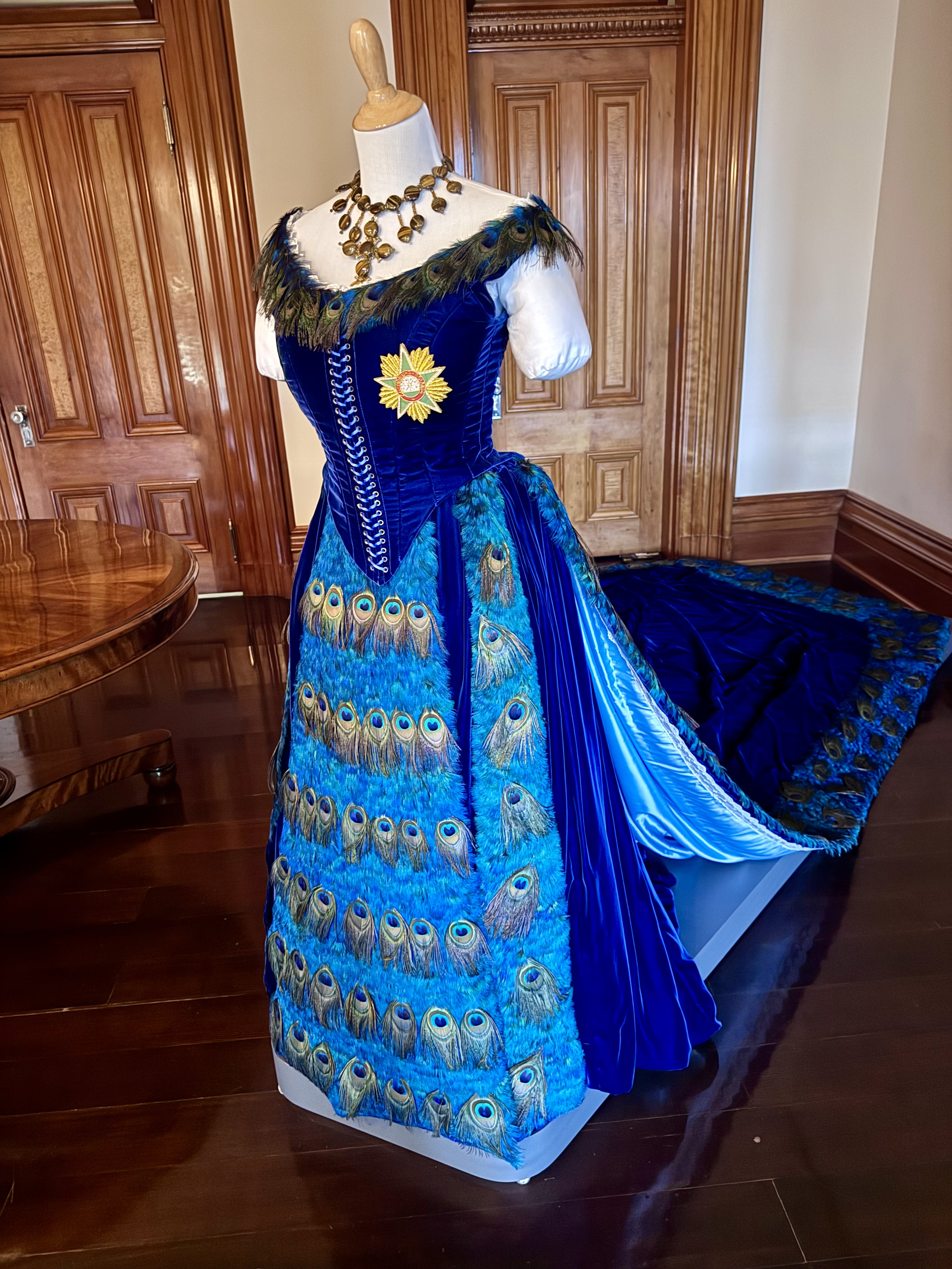 A peacock themed blue gown at Iolani Palace