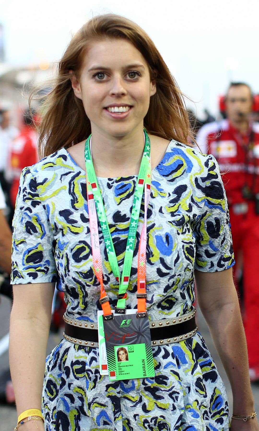 Princess Beatrice walking in a patterned dress on an F1 track