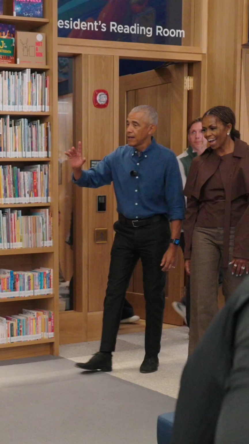 Barack and Michelle Obama read to kids in the Chicago Public Library branch at the Obama Presidential Center