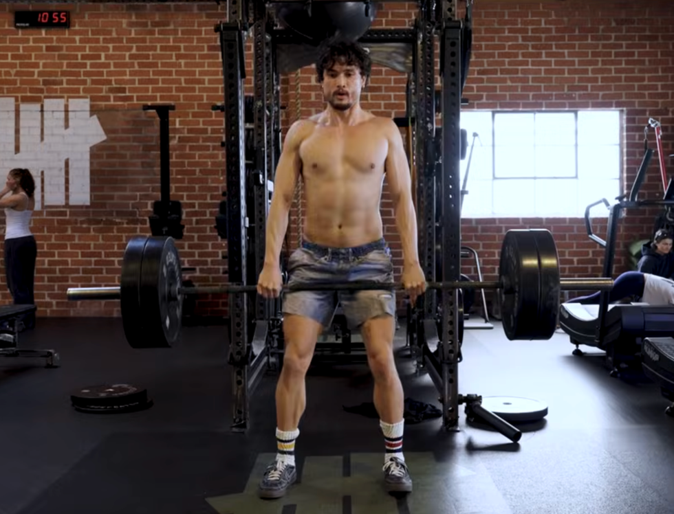 man performing a deadlift in a gym setting
