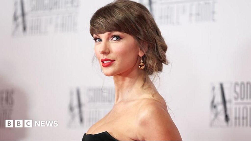 Taylor Swift: Singer tearfully thanks family as she makes history joining Songwriters Hall of Fame Taylor Swift smiling in a black, shoulderless dress and sparkling earrings