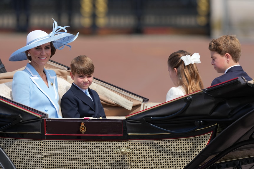 Princess Catherine and her children sit in a carriage.