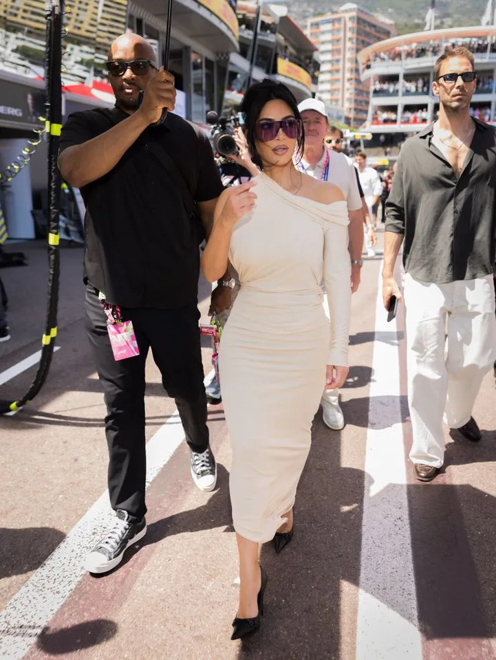 Kim Kardashian wore a fitted white asymmetrical dress for her second Grand Prix look.Credit: Getty