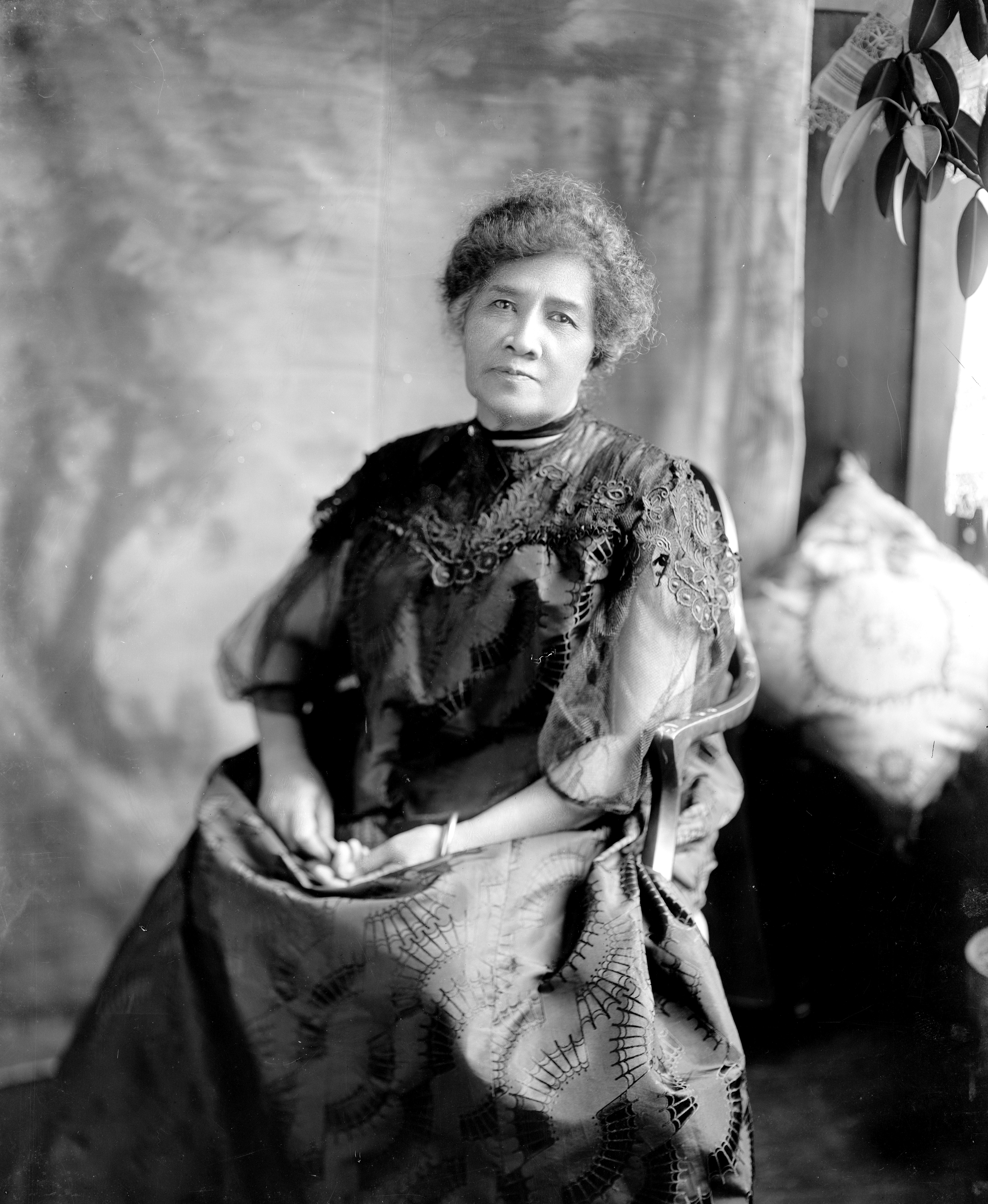 Queen Liliʻuokalani sitting in a chair for a portrait