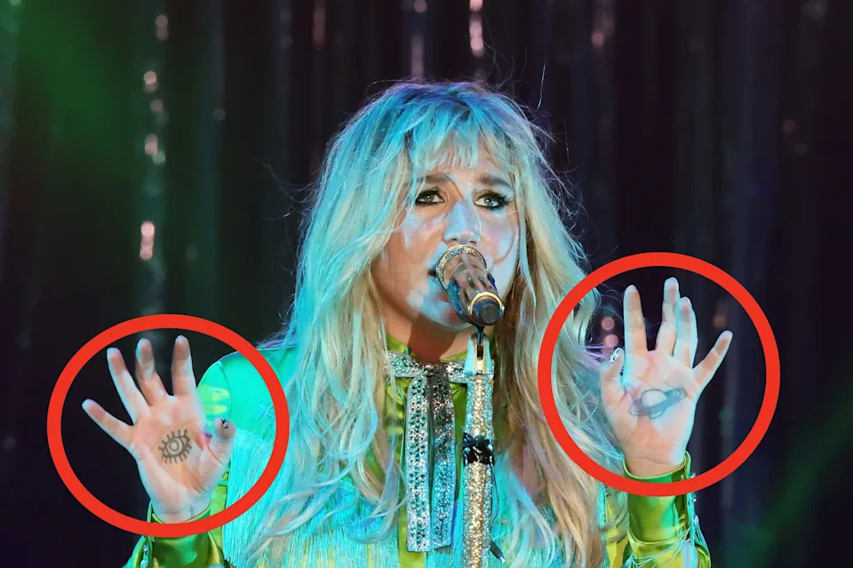 Singer performing passionately on stage, wearing a shimmering outfit with sparkling details, holding a microphone, expressive hand gestures visible