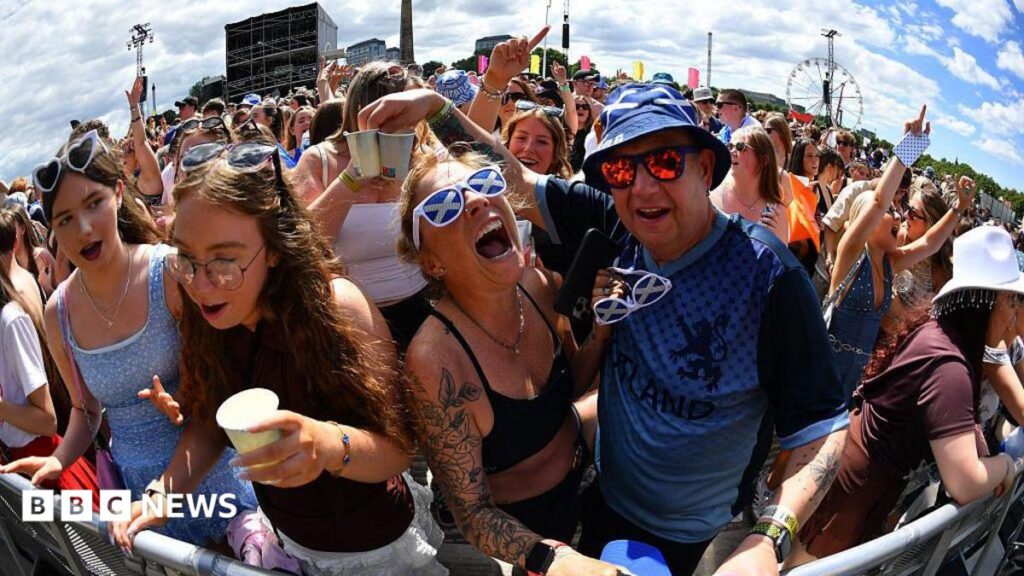 Sunny TRNSMT swaps ponchos for water bottles ahead of Lewis Capaldi closer Fans screaming and singing on a sunny day. One of the fans is wearing sunglasses with a saltire design.