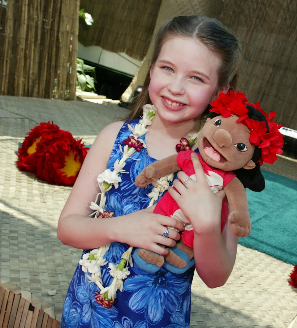 Daveigh Chase, voice of Lilo, holds a Lilo doll in 2002.
