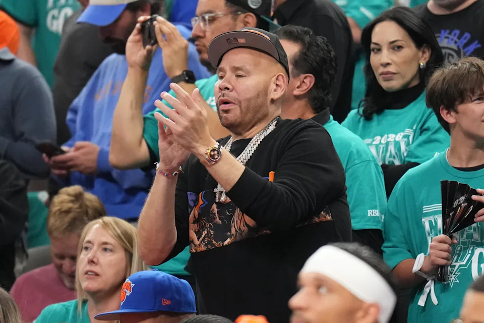 Fat Joe clapping his hands during the game.