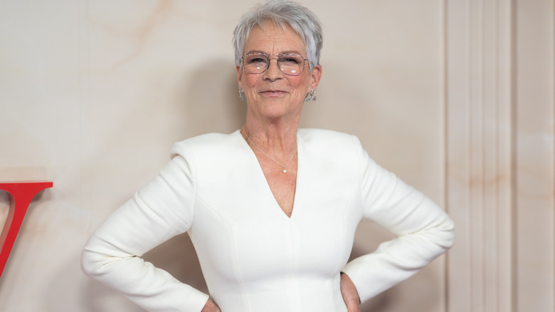 Jamie Lee Curtis posing in a white dress