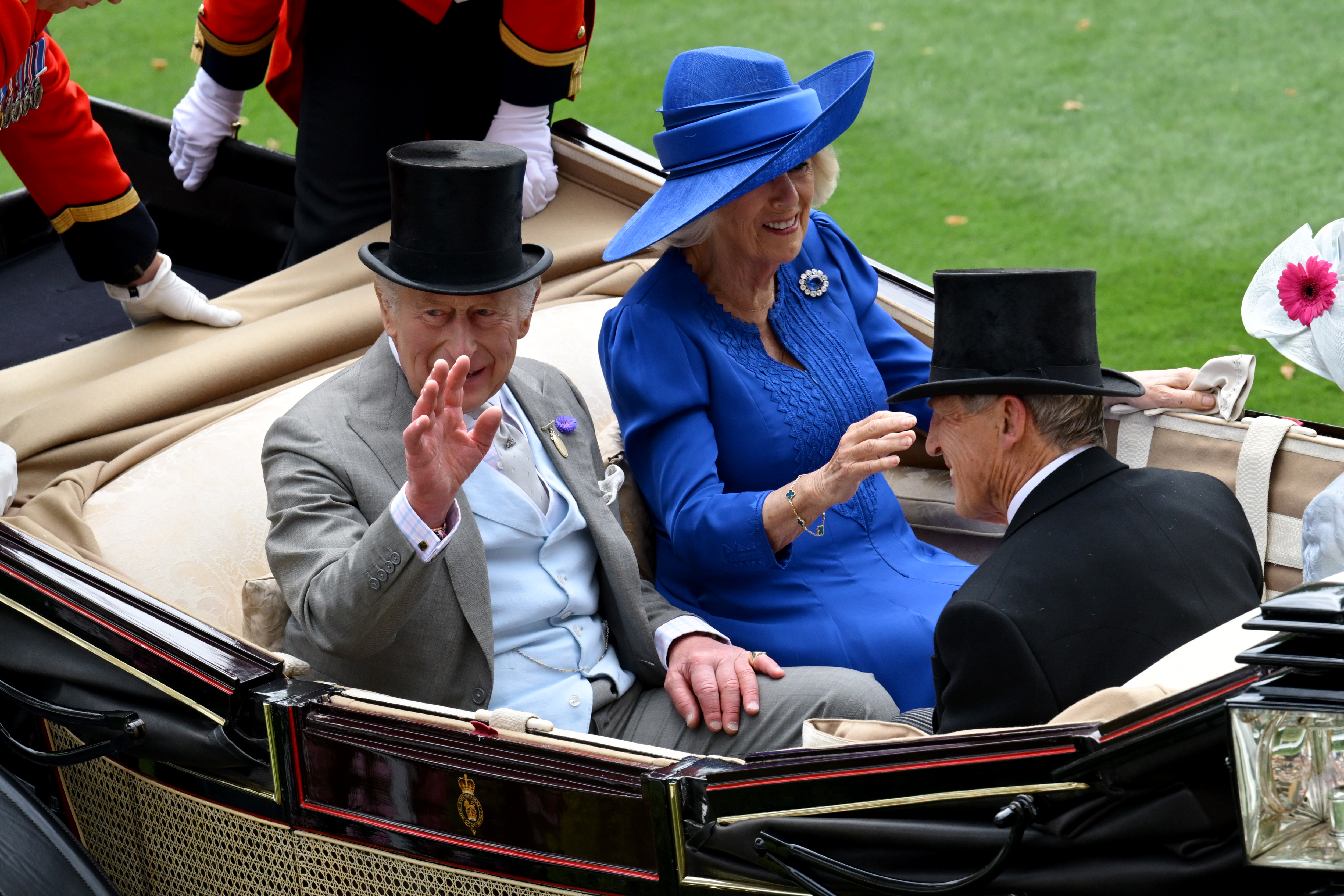 Queen Camilla riding in a carriage with King Charles at Ascot
