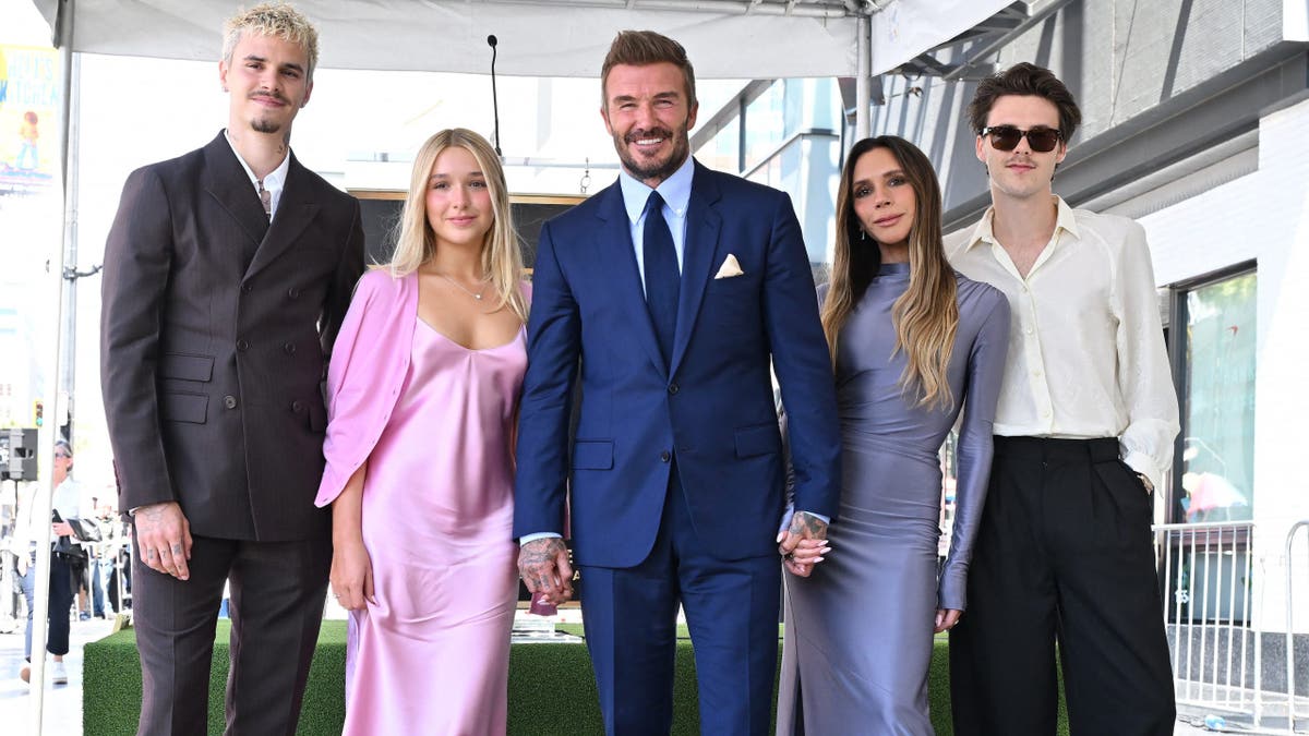 Romeo Beckham, Harper Beckham, David Beckham, Victoria Beckham and Cruz Beckham posing next to Hollywood Walk of Fame star.