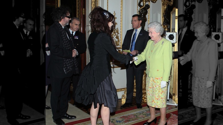 Queen Elizabeth II greeting Helena Bonham Carter and Tim Burton in 2012