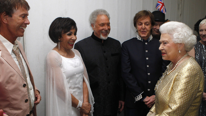 Queen Elizabeth II meeting Sir Cliff Richard, Dame Shirley Bassey, Sir Tom Jones and Sir Paul McCartney backstage after the Diamond Jubilee in 2012