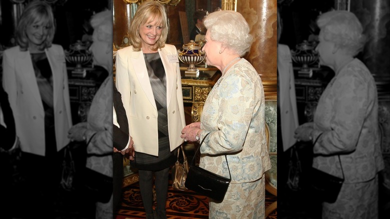 Queen Elizabeth II speaking with model Twiggy in 2010