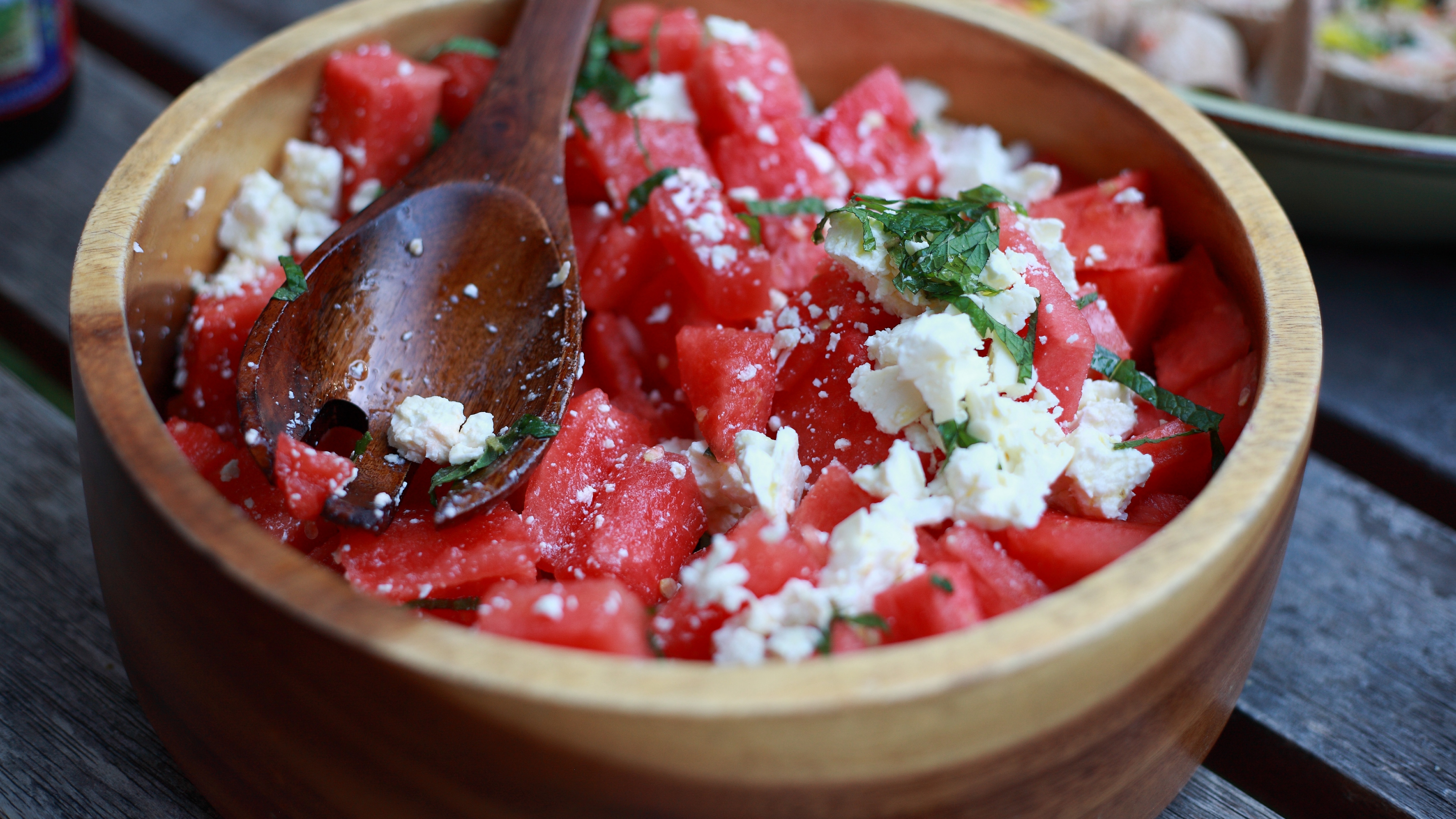 Stock photo of a watermelon and feta salad in a wooden bowl