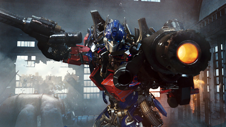 Optimus Prime prepares to fire his arm cannon in Transformers: Revenge of the Fallen