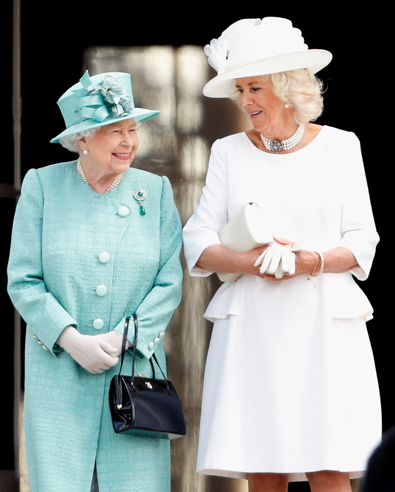 Queen Camilla and Queen Elizabeth smiling at each other