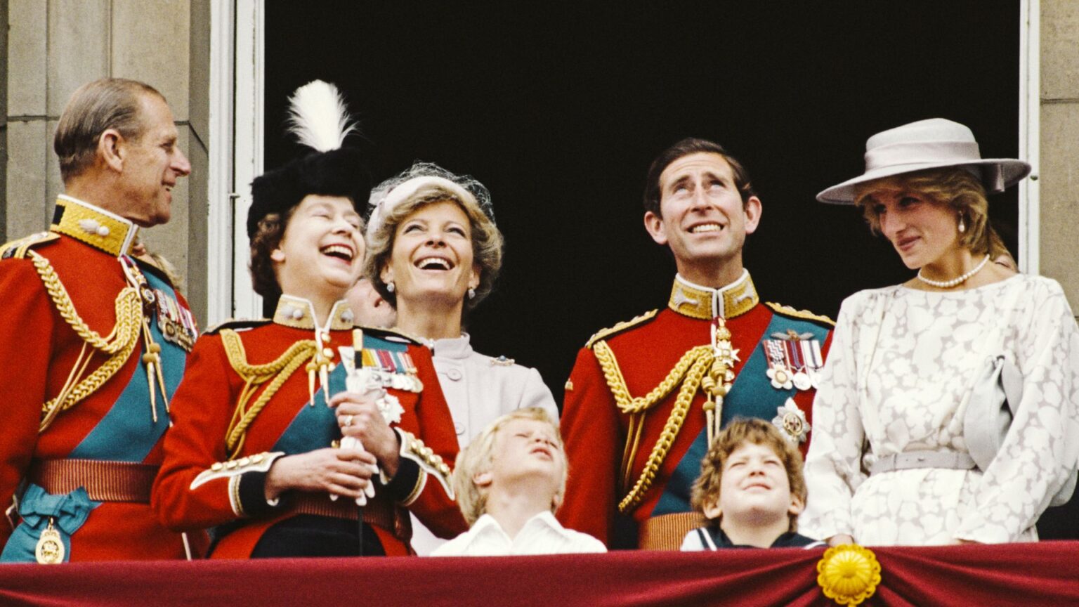 Princess Diana wears a white gown and matching hat on the Buckingham Palace balcony in 1983 for Trooping the Colour, alongside King Charles, Queen Elizabeth, Prince Philip, Princess Michael of Kent