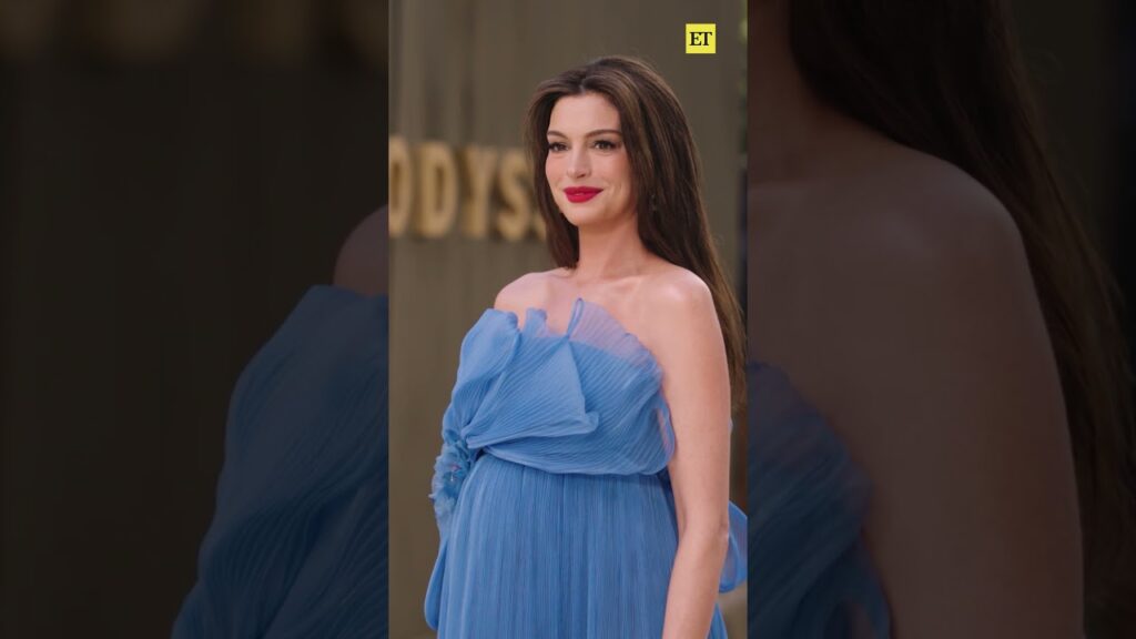 Anne Hathaway couldn’t help but laugh when photographers asked her to turn on 'The Odyssey’ carpet.