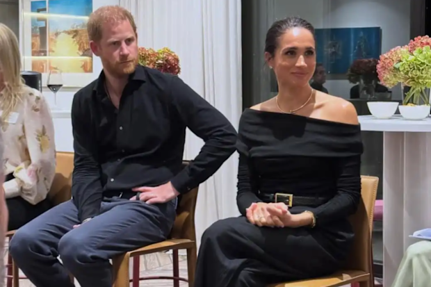 Meghan Markle and Prince Harry sitting side by side 